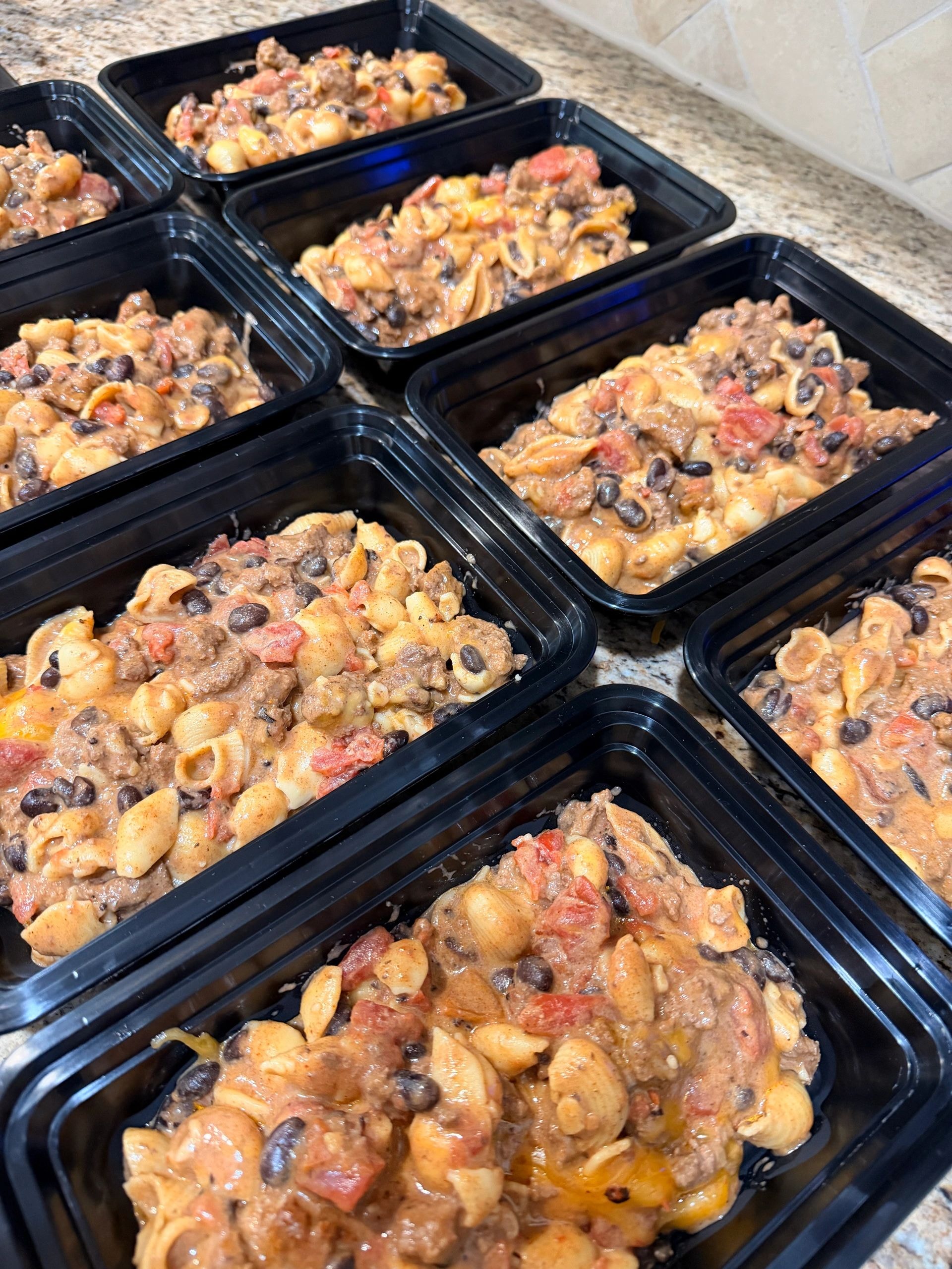 Meal prep containers with pasta and beef